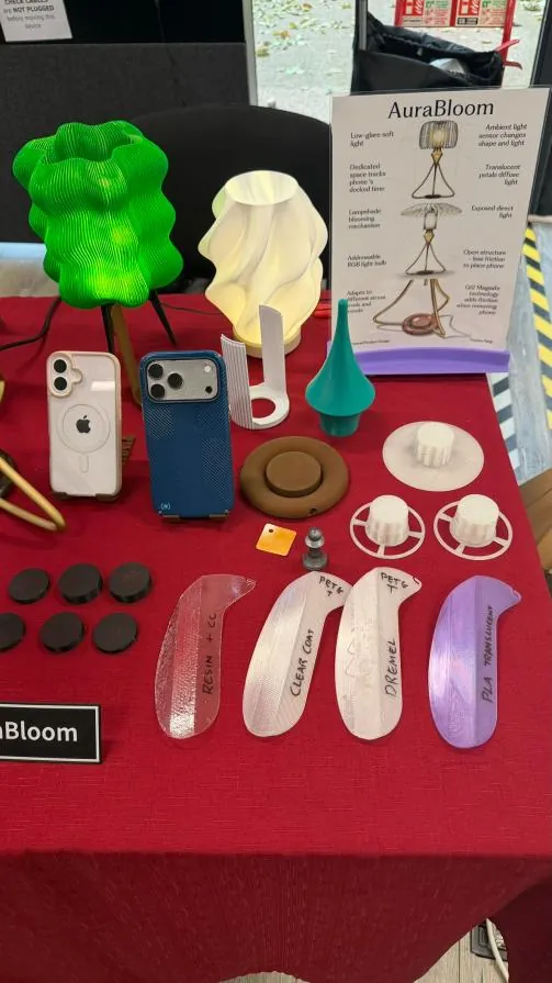 Showcase table with AuraBloom, test shades, phones and finishing samples on a red cloth