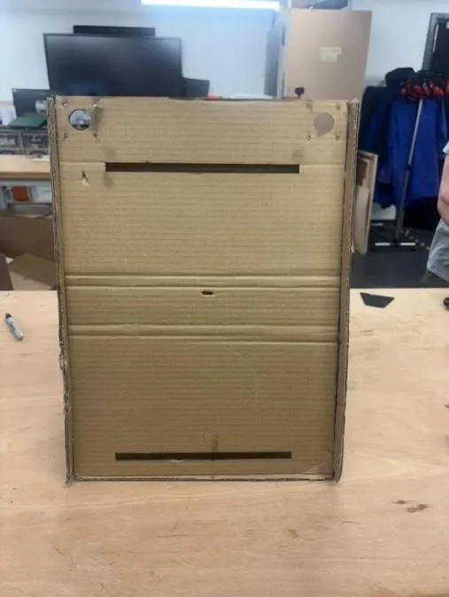 Front of cardboard model V2 with motor positions at the top and protruding sides for counterweights